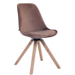 Tyylikäs pyörivä samettituoli puujalustalla ruokapöytään