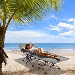 Taitettava harmaa retkisänky irrotettavalla patjalla ja tyynyllä