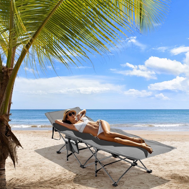 Taitettava harmaa retkisänky irrotettavalla patjalla ja tyynyllä