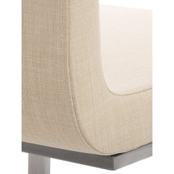 Moderni ruokapöydän tuoli keinuvalla teräsrungolla ja pehmeällä verhoilulla